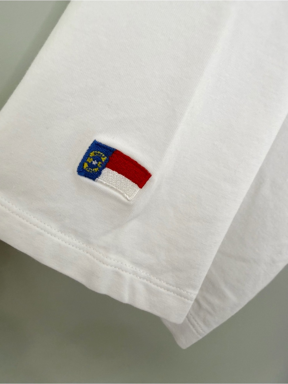 B.DRADDY Men’s Solid White Liam Polo with North Carolina flag and “B” Logo Patch - Picture 8 of 8